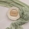 120-inch (10 ft) green cheesecloth table runner, perfect for adding a rustic boho touch to weddings, baby showers, bridal showers, or home décor. This sheer gauze runner serves as an elegant centerpiece, ideal for creating a soft, textured look on an
